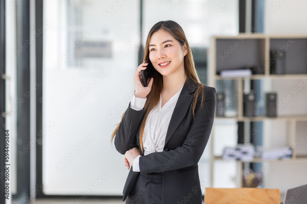 Young business Asian woman holding document file and Call phone stand in workplace office, Stack of business overload paper. Young business Asian woman holding document file and Call phone stand in workplace office, Stack of business overload paper.