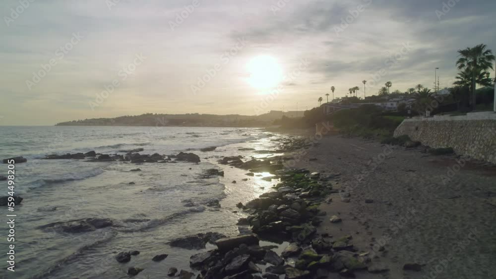 custom made wallpaper toronto digitalAerial moving forward and higher on a rocky beach during sunset in Mijas Costa, Andalusia, Spain