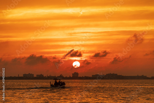 Boat at sea at sunset sky landscape