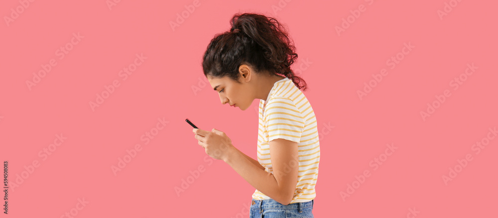 Young woman with bad posture using smartphone on pink background - obrazy, fototapety, plakaty 