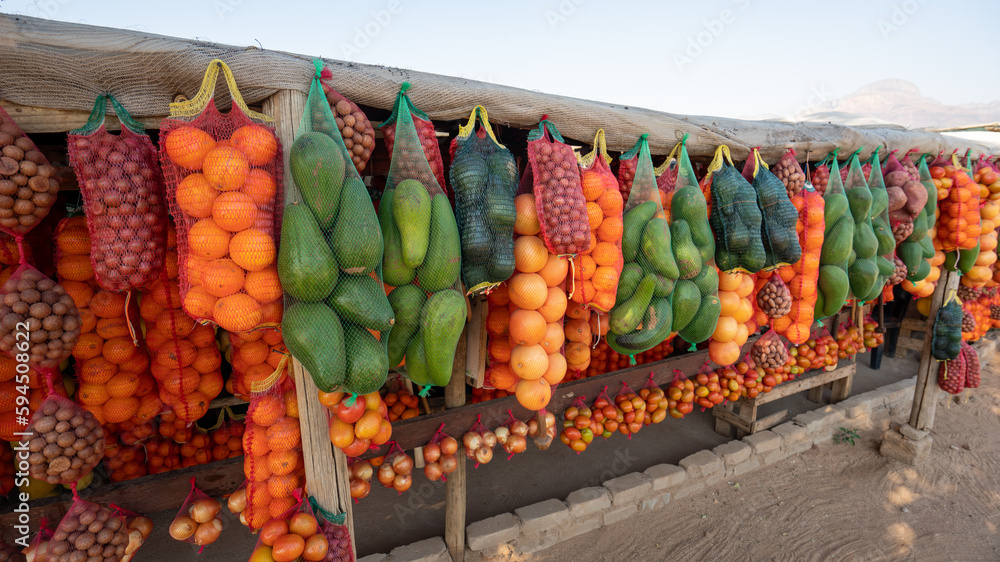 a roadside farmers market in South Africa displays fruits and vegetables for purchase. 