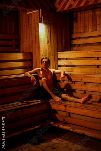 Man in hot sauna alone wood relaxing meditation terapy photo