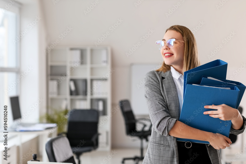 Female accountant with folders in office Female accountant with folders in office