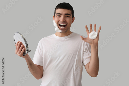 Funny young man applying sh...