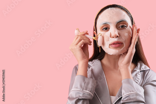 Young woman with sheet mask...