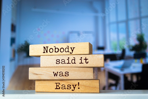 Wooden blocks with words 'Nobody said it was easy'. Business concept