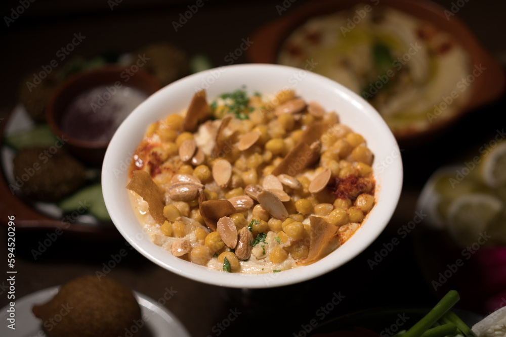Chickpeas, fried pita, and yogurt are mixed to create fatteh, a popular dish across the Middle East. Chickpeas, fried pita, and yogurt are mixed to create fatteh, a popular dish across the Middle East.