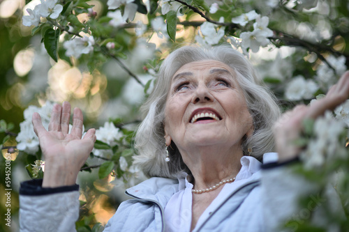 Portrait of happy senior woman smiling in autumn park