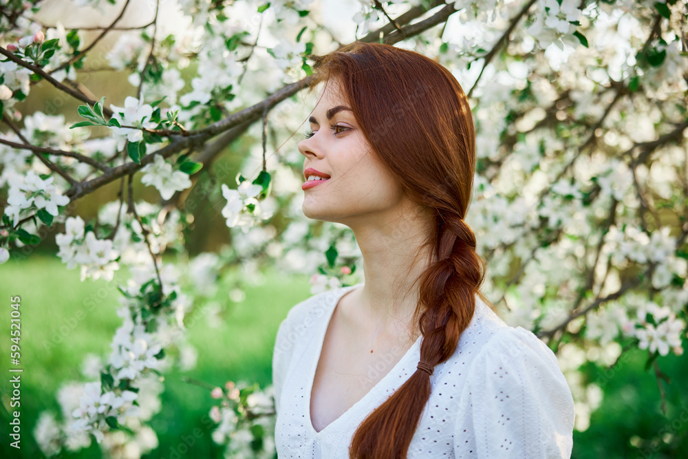 woman with flowers. gorgeous model in the spring garden. the girl near the tree in the spring. the concept of spring. young orchard woman with flowers. gorgeous model in the spring garden. the girl near the tree in the spring. the concept of spring. young orchard