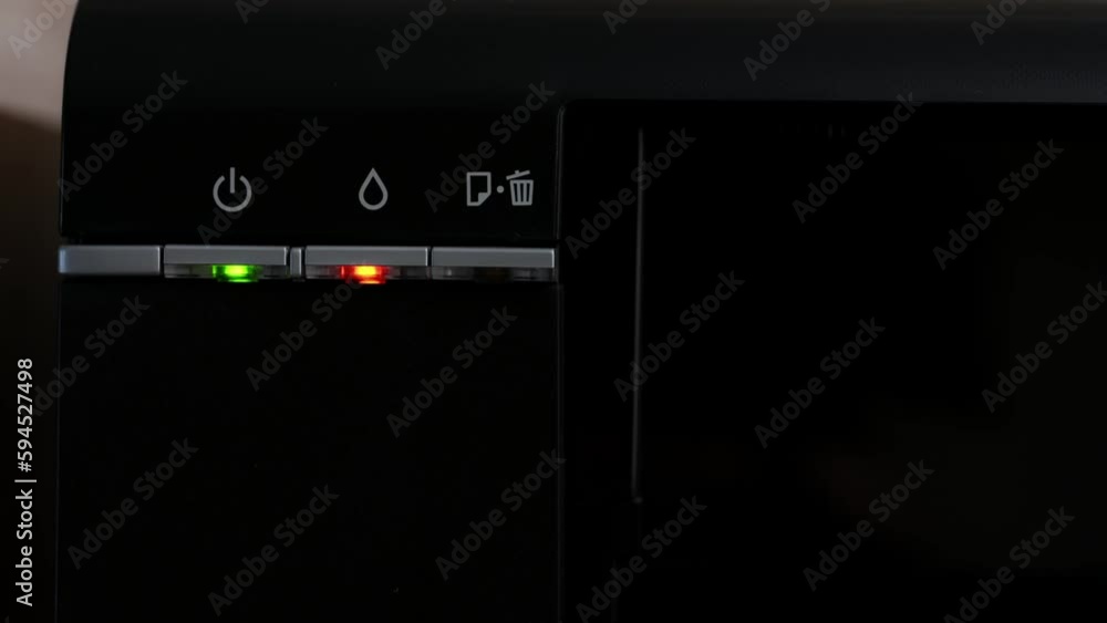The light on the printer is on with the red printer light, out of ink, close-up.Multifunction printer. The light on the printer is on with the red printer light, out of ink, close-up.Multifunction printer.