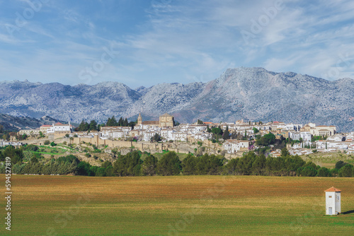 panoramic view of the city of ronda ,andalucia,spain with huge mountains in the background and farmland in the foreground
