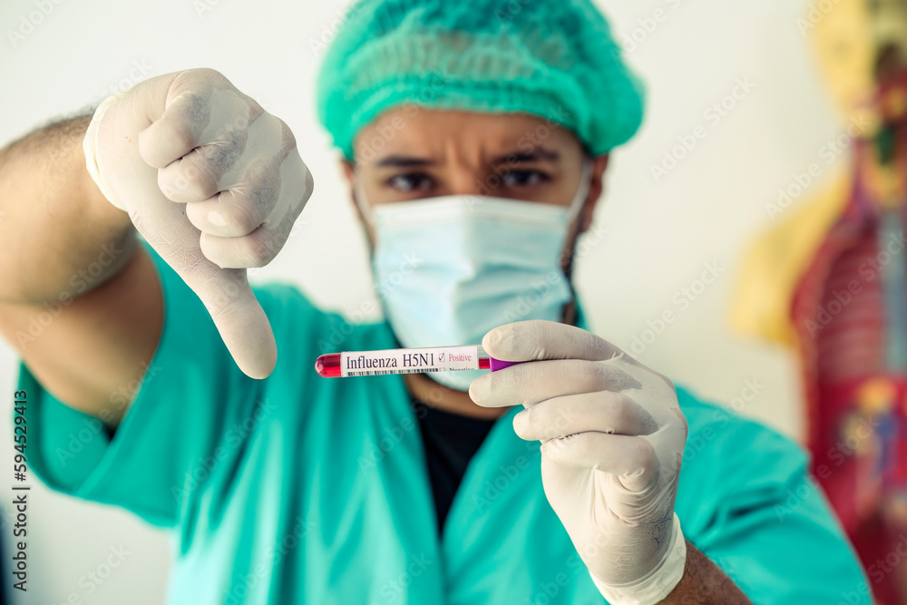 Caucasian doctor thumb down with positive Influenza H5N1 blood test tube. Caucasian doctor thumb down with positive Influenza H5N1 blood test tube.