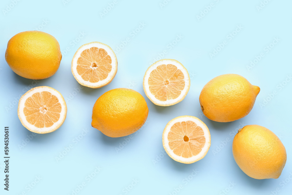 Composition with fresh lemons on blue background Composition with fresh lemons on blue background