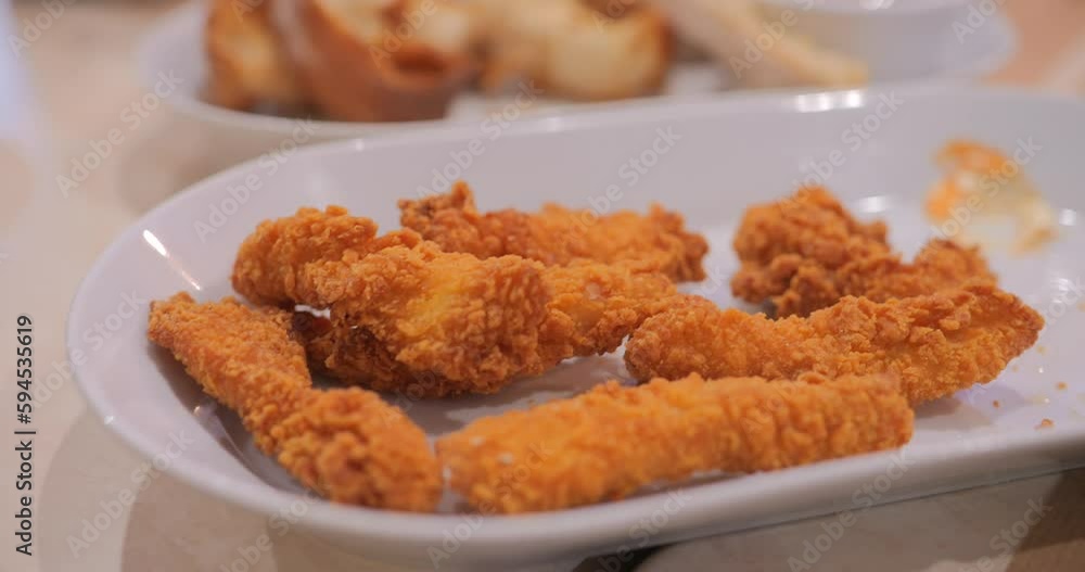 A Plate Of Crispy Chicken Fingers On The Table. - close up A Plate Of Crispy Chicken Fingers On The Table. - close up