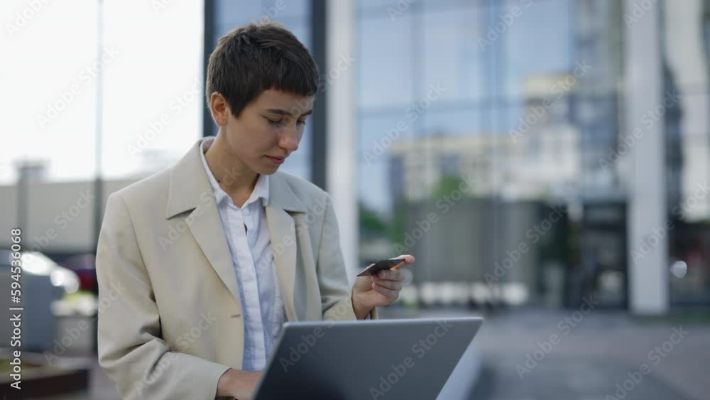 Woman Customer Using Laptop E-Banking Service Making Secure Online Payment Holding Credit Card in Hand. Female Buyer Paying on Website via E-Commerce Service Sitting Outdoors Woman Customer Using Laptop E-Banking Service Making Secure Online Payment Holding Credit Card in Hand. Female Buyer Paying on Website via E-Commerce Service Sitting Outdoors
