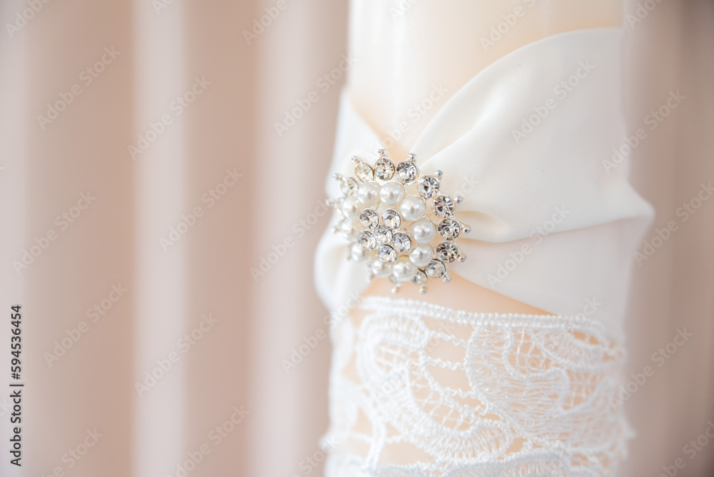Close Up of White Candle with Diamond and Pearl Broach