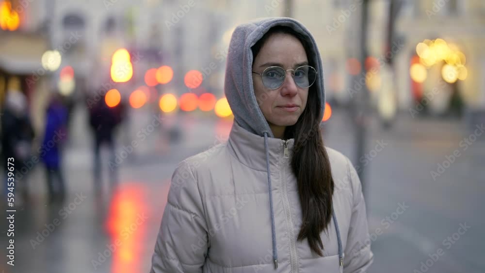 middle-aged female city dweller walking alone on street in winter or autumn day, medium portrait middle-aged female city dweller walking alone on street in winter or autumn day, medium portrait