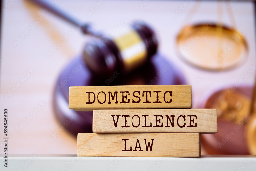 Wooden blocks with words 'Domestic violence law'. Legal concept