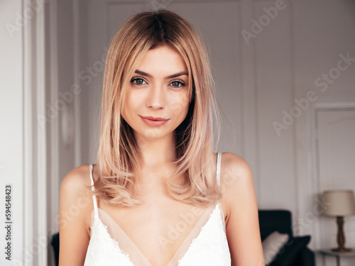 Fotografi Young beautiful smiling blond female in trendy nightdress clothes