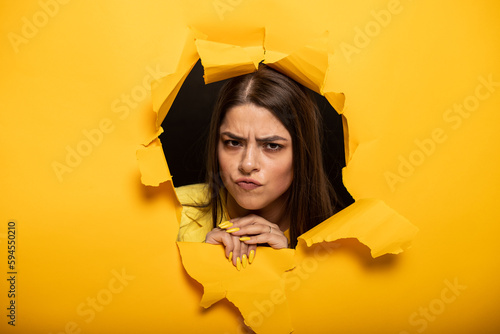 portrait of woman tearing yellow background © Светлана Амелина