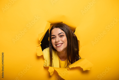 portrait of woman tearing yellow background © Светлана Амелина