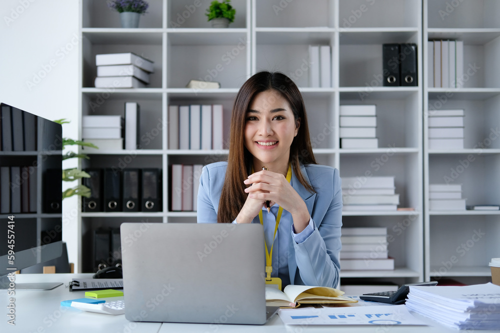 Portrait of smiling beautiful business asian woman with working in modern office desk using laptop computer, Business people employee freelance online marketing e-commerce telemarketing concept. Portrait of smiling beautiful business asian woman with working in modern office desk using laptop computer, Business people employee freelance online marketing e-commerce telemarketing concept.
