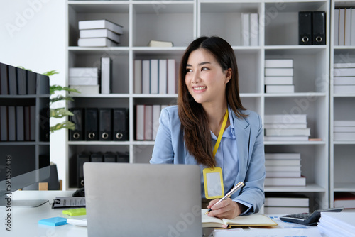 Smiling businesswoman working at laptop © Sucharat