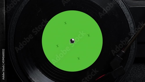 Close up of a vintage retro vinyl record with green sticker rotating. Top view. Old fashioned music. Needle gramophone. 4K ProRes