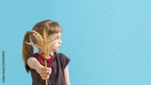 Child holding symbol gluten free food. Banner international day of celiac disease.