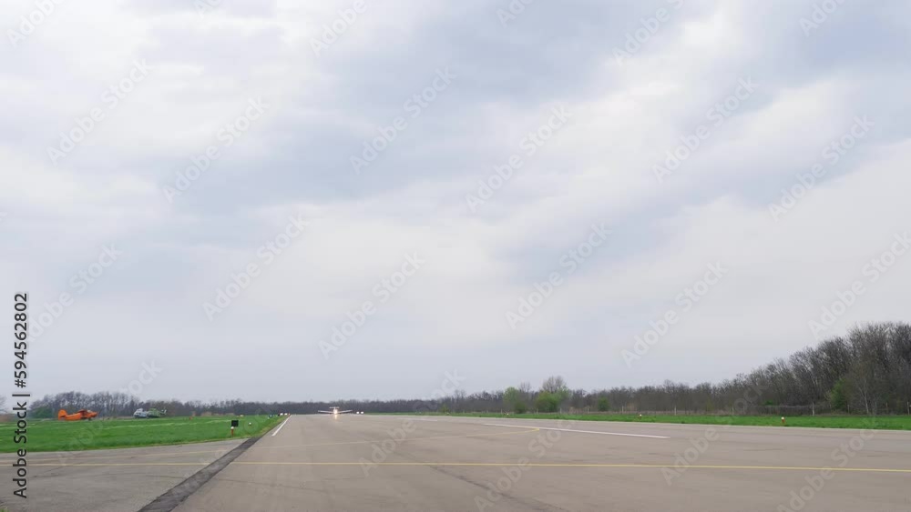 Single engine propeller airplane is standing in front of a closed aircraft hangar. Transportation for tourists and locals. Small white airplane heading towards airstrip for before flight Single engine propeller airplane is standing in front of a closed aircraft hangar. Transportation for tourists and locals. Small white airplane heading towards airstrip for before flight