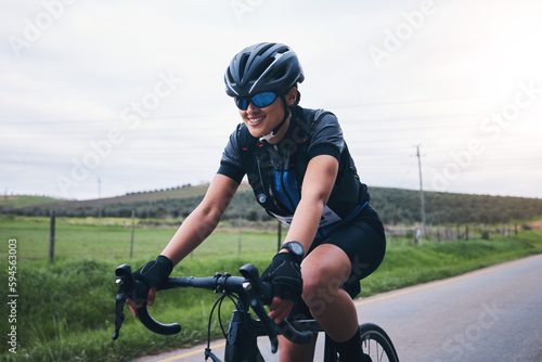 Sports, nature and female athlete cycling on a bicycle training for a race, marathon or competition. Fitness, workout and woman cyclist riding bike for cardio exercise on outdoor road in the mountain