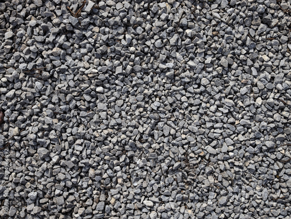 Gray stone gravel texture background. Broken stone or crushed rock texture with place for text. dark background of crushed granite gravel, close up top view. Gray stone gravel texture background. Broken stone or crushed rock texture with place for text. dark background of crushed granite gravel, close up top view.