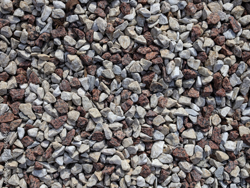 Gravel seamless texture close up..Gray and brown gravel stones for the construction industry.Small stones gravel background, . decoration in the gardening top view