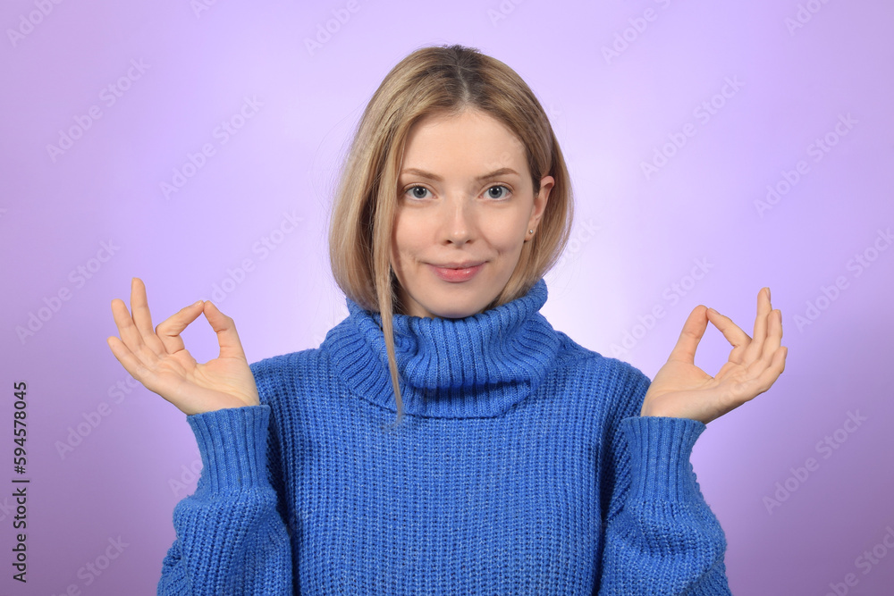 Young blonde woman with short hair smiling and holding fingers together Young blonde woman with short hair smiling and holding fingers together
