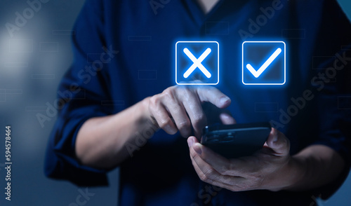 Businessman using smartphones show right and wrong symbols. yes or no decision 