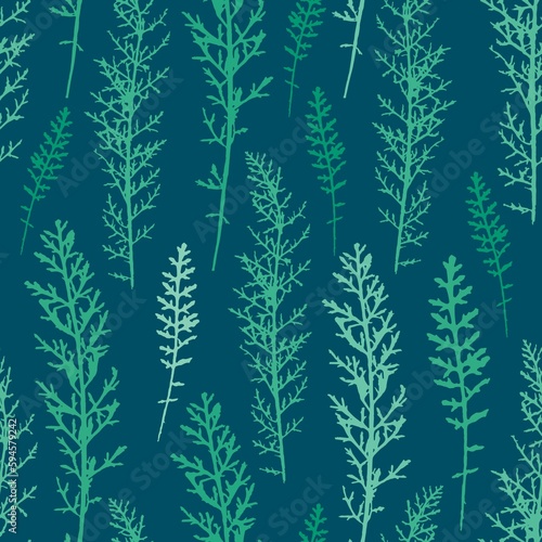 Seamless pattern with leaves of field plants in different shades of green on a dark blue background. Natural background with plant silhouettes. Design for fabric  packaging  cover  textiles.