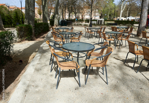 tables and chairs on the terrace of an outdoor bar