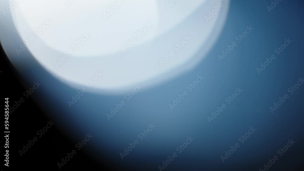 Glittering Blue Bokeh Lights with Blurred Circles and Shiny Sparkles on a Dark Background Glittering Blue Bokeh Lights with Blurred Circles and Shiny Sparkles on a Dark Background
