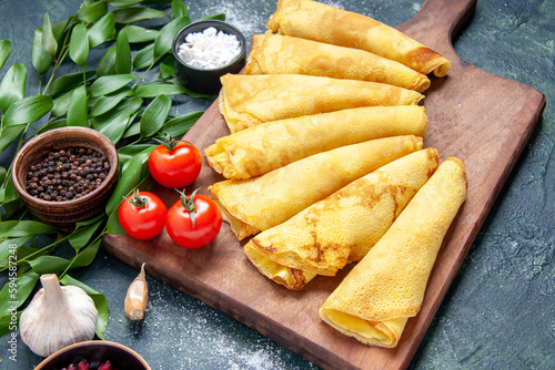 Obraz na plátně front view tasty pancakes rolled on dark background pastry hotcake dough pie mea