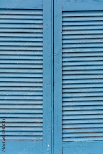 Closed blue wooden window shutters as a background texture