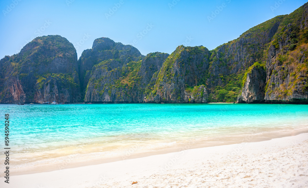Obraz premium Maya Bay, Ko Phi Phi Leh island, part of Krabi, Thailand. View round with steep limestone hills and emerald green water.