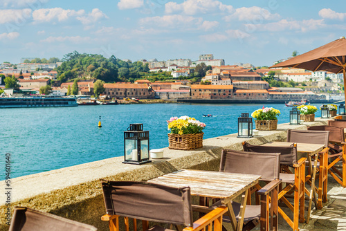 View of open-air street cafe on the banks of the River Douro in Porto, Portugal