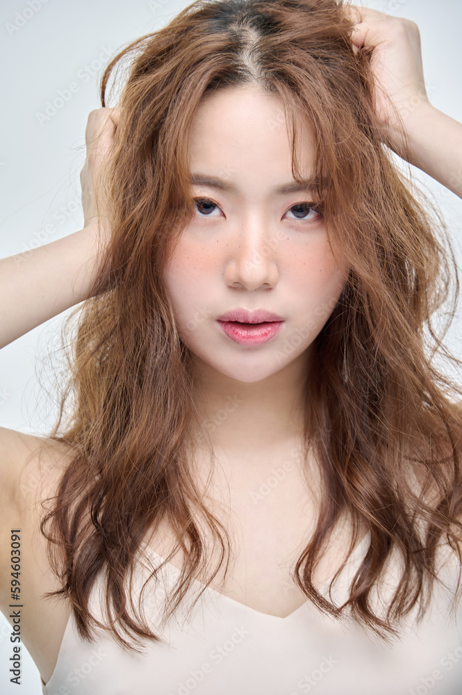 Beautiful Young Asian woman with clean fresh skin touching two hands on face in beauty pose. Pretty girl smiling in white background. Facial treatment, cosmetology, cosmetic surgery, make up concept. Beautiful Young Asian woman with clean fresh skin touching two hands on face in beauty pose. Pretty girl smiling in white background. Facial treatment, cosmetology, cosmetic surgery, make up concept.