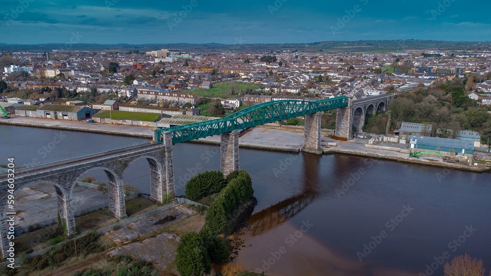Amazing Boyne viaduct in drogheda spanning over river Boyne in early evening hours. Beautiful pucture of a green metal viaduct and stone arches.