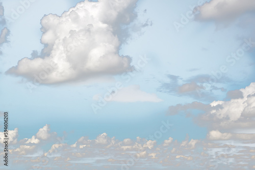 Small white fluffy clouds on the blue sky.