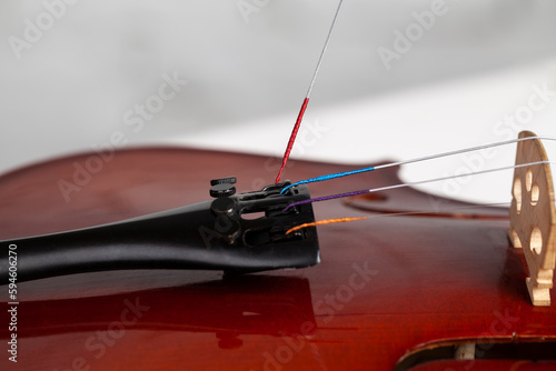 Foto Violin on studio background. String stretching process.