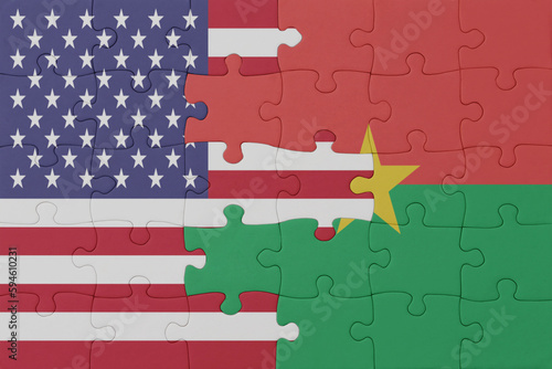 puzzle with the national flag of burkina faso and united states of america.macro