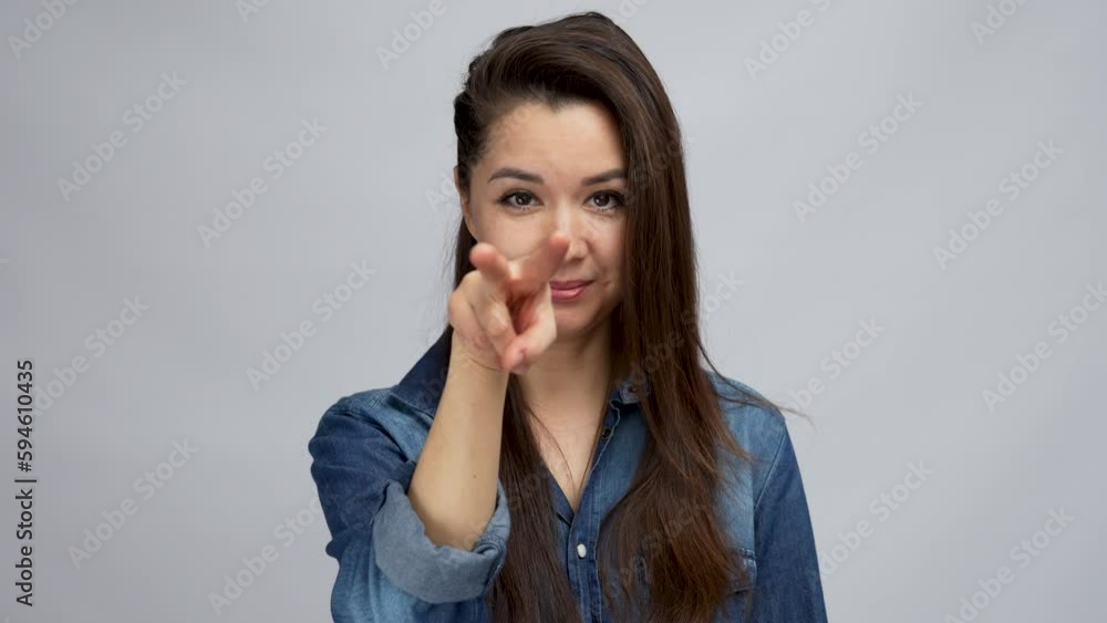Young beautiful woman pointing to the eye watching you gesture Young beautiful woman pointing to the eye watching you gesture
