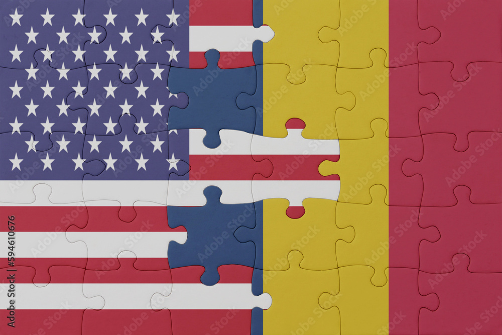 Obraz premium puzzle with the national flag of chad and united states of america.macro
