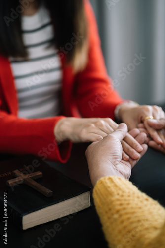 Asian men and women hands praying to god with the bible. Pray for god blessing. Religious beliefs Christian life crisis prayer to god.